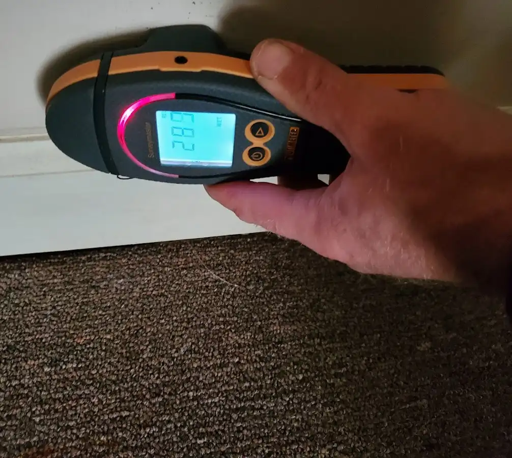 Moisture detection at baseboard during Storm Damage Restoration in Durango